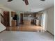 Open concept living room featuring hardwood floors, a ceiling fan, and an adjacent kitchen at 10150 Beresford Ct, Fishers, IN 46038