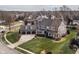 Spacious property with manicured lawn, three-car garage, and beautiful landscaping, seen from an aerial perspective at 10974 Harbor Bay Dr, Fishers, IN 46040