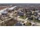 Aerial view of a neighborhood featuring tree-lined streets and well-maintained homes near a river at 10974 Harbor Bay Dr, Fishers, IN 46040
