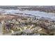 Breathtaking aerial view of a residential area with homes nestled along a stunning, partially frozen lake at 10974 Harbor Bay Dr, Fishers, IN 46040