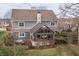 Back of the house featuring a screened porch, stone chimney, and mature landscaping, taken from an elevated view at 10974 Harbor Bay Dr, Fishers, IN 46040