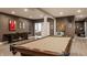 Finished basement featuring a pool table, shuffleboard, and barn doors at 10974 Harbor Bay Dr, Fishers, IN 46040