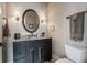 Bathroom with granite countertop, dark wood vanity, and modern fixtures at 10974 Harbor Bay Dr, Fishers, IN 46040