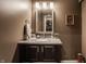 Powder room with granite countertop, modern vanity, and decorative mirror at 10974 Harbor Bay Dr, Fishers, IN 46040