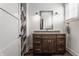 Bathroom with dark wood vanity, granite countertop, and decorative mirror at 10974 Harbor Bay Dr, Fishers, IN 46040