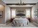 An inviting bedroom features a tufted headboard, soft lighting, and neutral tones for a serene atmosphere at 10974 Harbor Bay Dr, Fishers, IN 46040
