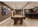 A spacious game room features a pool table, bar area, and inviting ambiance at 10974 Harbor Bay Dr, Fishers, IN 46040
