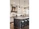 Modern kitchen with a large center island, custom range hood and pendant lighting at 10974 Harbor Bay Dr, Fishers, IN 46040