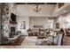 Cozy living room boasts a stone fireplace, comfortable seating, and lots of natural light at 10974 Harbor Bay Dr, Fishers, IN 46040