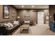 Basement living room with leather sofas, area rug, and barn door accent at 10974 Harbor Bay Dr, Fishers, IN 46040