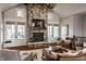 Inviting living room features a stone fireplace, beamed ceilings, and multiple french doors at 10974 Harbor Bay Dr, Fishers, IN 46040