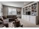 Cozy living room with built-in shelving, sectional sofa, and area rug at 10974 Harbor Bay Dr, Fishers, IN 46040