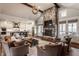 Spacious living room with a grand stone fireplace, comfortable seating, and an open layout to the kitchen at 10974 Harbor Bay Dr, Fishers, IN 46040