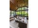 Inviting screened-in patio featuring a wood ceiling, comfortable wicker furniture, and views of the lush backyard at 10974 Harbor Bay Dr, Fishers, IN 46040