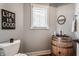 Unique powder room with a rustic barrel sink and a modern toilet, blending charm with modern design at 10974 Harbor Bay Dr, Fishers, IN 46040