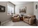 A cozy sitting room features comfortable armchairs, soft lighting, and a serene ambiance at 10974 Harbor Bay Dr, Fishers, IN 46040