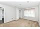 Neutral bedroom with closet, carpet, and a large window providing plenty of natural light at 1124 Paradise Ct # B, Greenwood, IN 46143