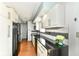 Modern kitchen boasting white cabinets, black countertops, stainless steel appliances, and stylish backsplash at 1124 Paradise Ct # B, Greenwood, IN 46143