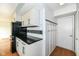 Efficient kitchen layout with black appliances, black counters, white cabinets, and a coat rack for convenience at 1124 Paradise Ct # B, Greenwood, IN 46143