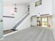 Inviting living room with stairs, an open layout, neutral carpeting, and easy access to the kitchen at 1124 Paradise Ct # B, Greenwood, IN 46143