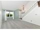 Light-filled living room featuring plush carpeting, fresh paint, and a staircase leading to the upper level at 1124 Paradise Ct # B, Greenwood, IN 46143