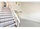 Staircase with decorative patterned treads and a landing providing view of adjacent living area at 1124 Paradise Ct # B, Greenwood, IN 46143