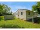 Home exterior showing a chain link fence, shed, and lawn in the backyard at 1141 Madeira St, Indianapolis, IN 46203