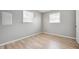 Inviting bedroom with wood-look flooring, neutral walls, and bright windows creating a warm and airy ambiance at 1141 Madeira St, Indianapolis, IN 46203