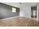 Spacious bedroom features wood-look flooring, neutral walls, and natural light creating a cozy atmosphere at 1141 Madeira St, Indianapolis, IN 46203