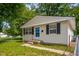 Charming single-story home with neutral siding, dark shutters, and a well-maintained lawn and landscaping at 1141 Madeira St, Indianapolis, IN 46203