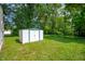 Metal shed on the lawn in the backyard with green trim and a white exterior at 1141 Madeira St, Indianapolis, IN 46203
