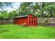 Backyard featuring a red storage shed and a wooden fence at 11630 Deanna Dr, Indianapolis, IN 46229