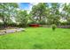 Backyard featuring a storage shed, wooden deck, and tree at 11630 Deanna Dr, Indianapolis, IN 46229