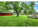 Beautiful backyard featuring lush greenery, a large tree, and a wooden deck at 11630 Deanna Dr, Indianapolis, IN 46229