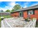 Spacious backyard featuring a wooden deck, bench seating, and a well-maintained lawn at 11630 Deanna Dr, Indianapolis, IN 46229