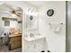 Well-lit bathroom with a white vanity, mirror, and a shower, blending functionality at 11630 Deanna Dr, Indianapolis, IN 46229