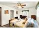 Cozy bedroom with a ceiling fan, dresser, and trunk at the end of the bed, creating a relaxing retreat at 11630 Deanna Dr, Indianapolis, IN 46229