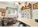 Well-lit craft room featuring multiple tables and window for comfort and functionality at 11630 Deanna Dr, Indianapolis, IN 46229