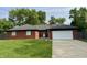 Charming brick home with a well-manicured lawn and attached two-car garage at 11630 Deanna Dr, Indianapolis, IN 46229