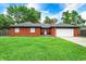 Charming brick home with a well-manicured lawn and attached two-car garage at 11630 Deanna Dr, Indianapolis, IN 46229
