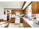 Well-equipped kitchen with vintage wooden cabinets, white appliances, and bright, airy feel at 11630 Deanna Dr, Indianapolis, IN 46229