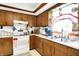 Bright kitchen featuring ample counter space, traditional cabinets, and classic white appliances at 11630 Deanna Dr, Indianapolis, IN 46229
