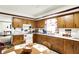 Well-lit kitchen boasts wooden cabinets, white countertops, and a breakfast nook at 11630 Deanna Dr, Indianapolis, IN 46229