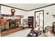 Cozy living room boasts a brick fireplace, comfortable seating, and charming decor, perfect for relaxation at 11630 Deanna Dr, Indianapolis, IN 46229