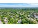An aerial view shows the neighborhood and home surrounded by mature trees at 12043 Searay Dr, Indianapolis, IN 46236