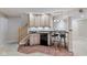 Basement wet bar including a sink, dishwasher, and seating with a tiled floor at 12043 Searay Dr, Indianapolis, IN 46236