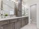 This bathroom offers a dual sink vanity with dark cabinetry and modern fixtures at 12043 Searay Dr, Indianapolis, IN 46236