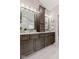 The bathroom features a dual sink vanity with dark cabinetry and modern light fixtures at 12043 Searay Dr, Indianapolis, IN 46236