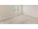 An empty bedroom offers plenty of sunlight through the large window with blinds at 12043 Searay Dr, Indianapolis, IN 46236