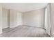 Spacious room with wood-look floors, neutral paint, and a white door at 12043 Searay Dr, Indianapolis, IN 46236